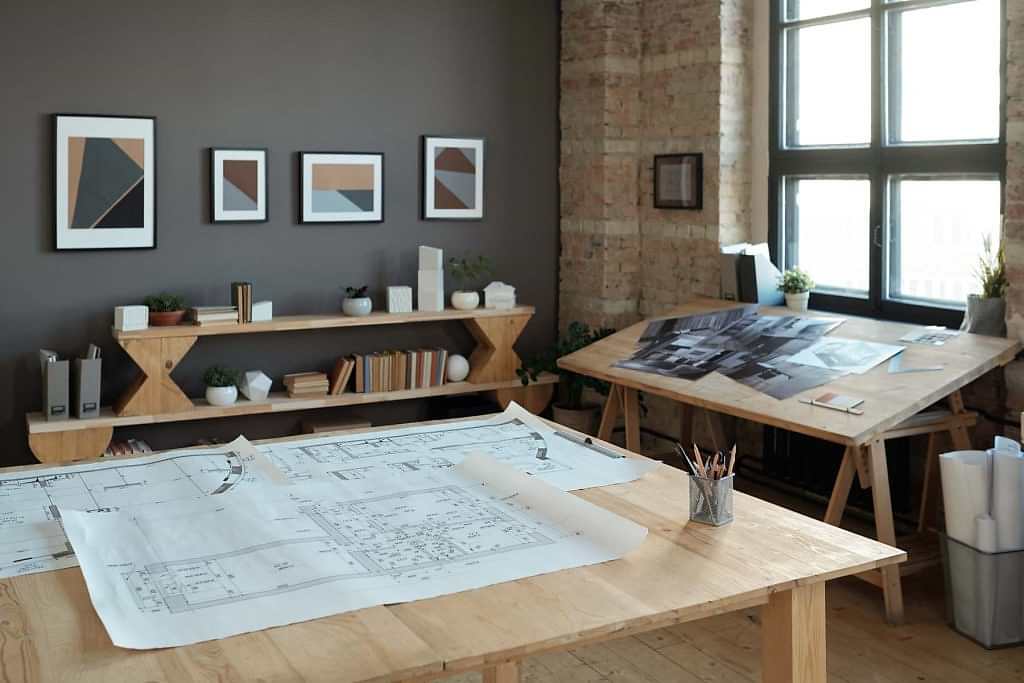 Architectural blueprints and design sketches showing detailed planning for an interior design project